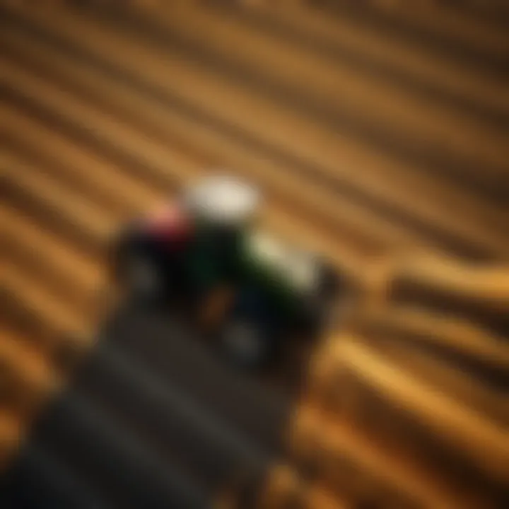 Aerial view of a tractor equipped with GPS auto steer technology plowing a field