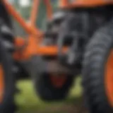 A close-up view of a mower sleeve hitch attached to a tractor showcasing its robust design.